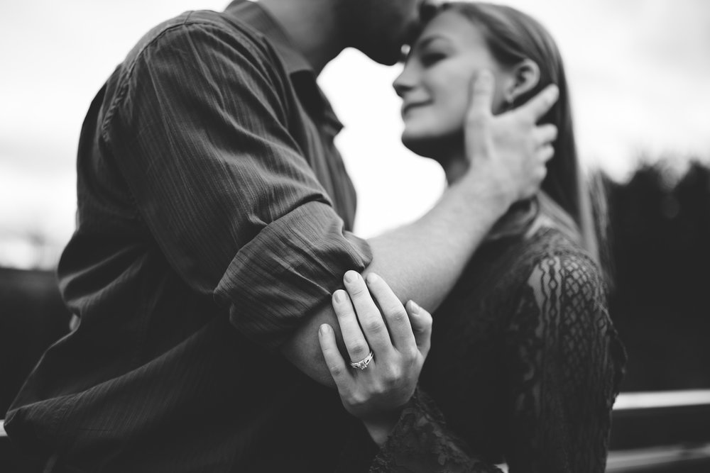  black and white engagement photo with forehead kiss 
