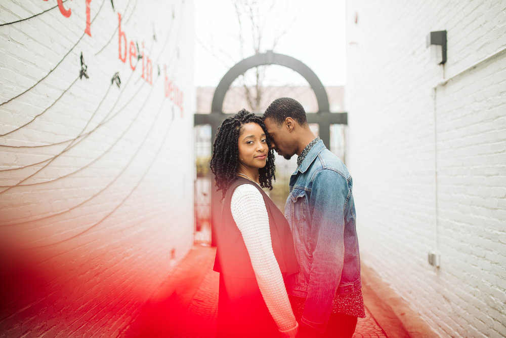  engagement photos with couple holding hands in alley 