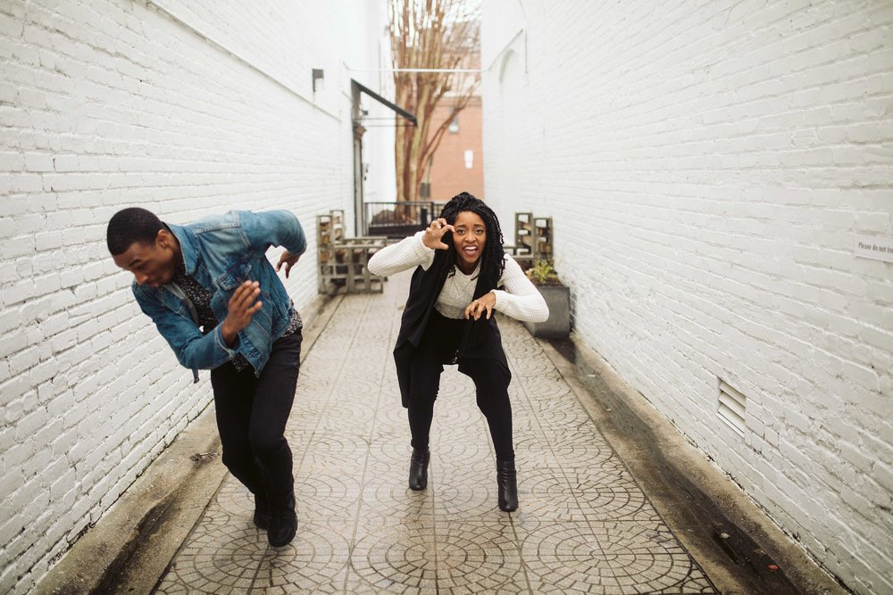  couple running and laughing for engagement photo 