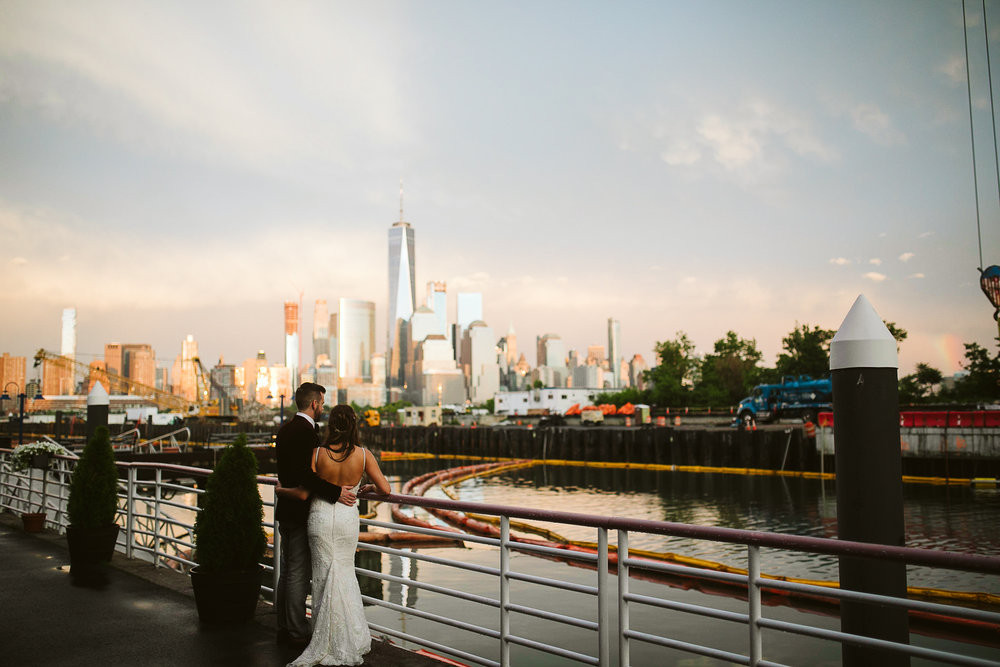  The bride and groom portrait with NYC and the bay at sunset at this Battello Wedding in Jersey City, NJ 