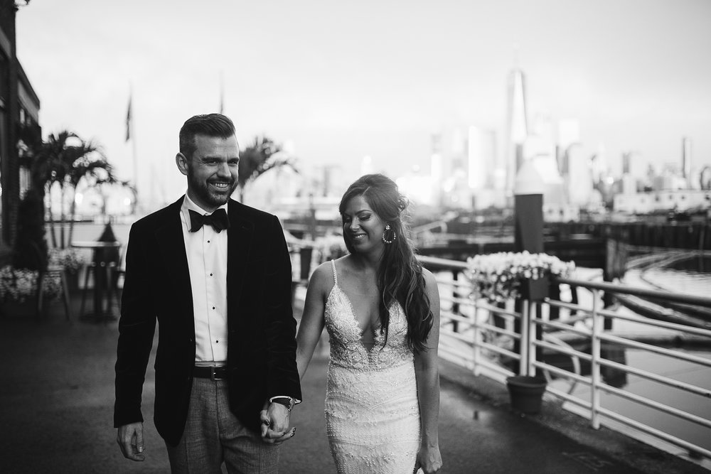  A black and white portrait of the bride and groom with NYC and the bay behind them at this Battello Wedding in Jersey City, NJ 