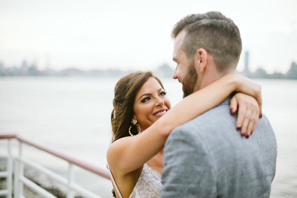  A portrait of the bride and groom with NYC and the bay behind them at this Battello Wedding in Jersey City, NJ 