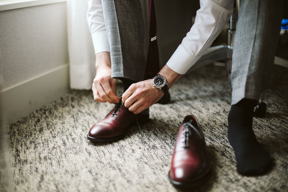  The groom getting ready and putting on his shoes at this Battello Wedding in Jersey City, NJ 