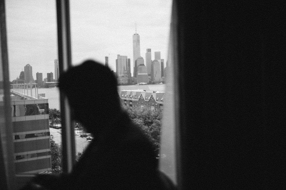  A black and white silhouette photo of the groom with a city backdrop at this Battello Wedding in Jersey City, NJ 