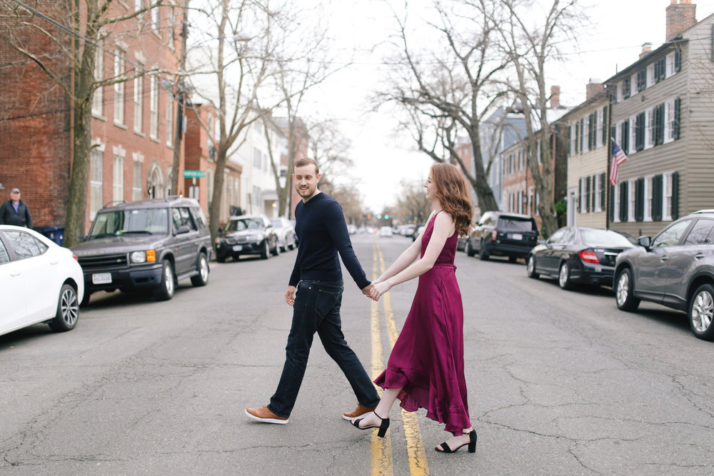  A leather jacket and maroon dress crossing the street at this DC Area Engagement Shoot - Alexandria, VA 