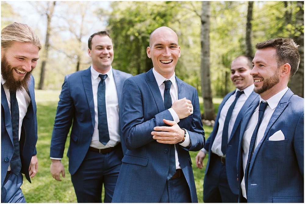  groomsmen and groom in navy suits 