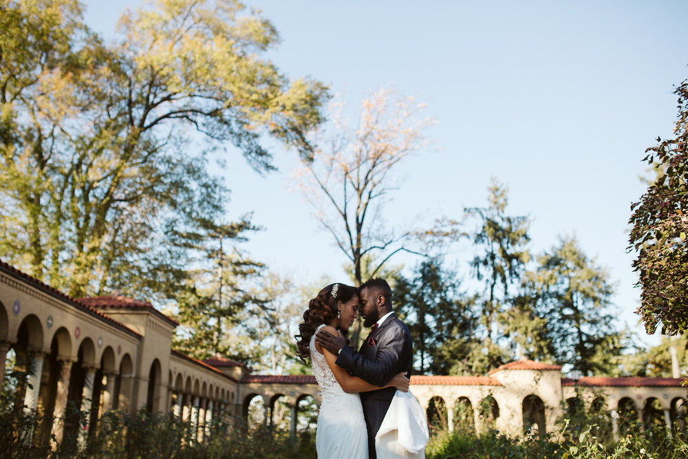  bride and groom embrace outside st francis hall 