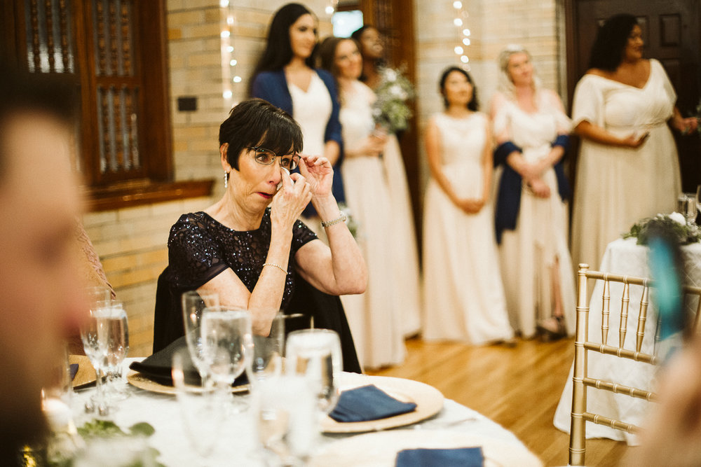  mother of the bride cries during st francis hall wedding reception 