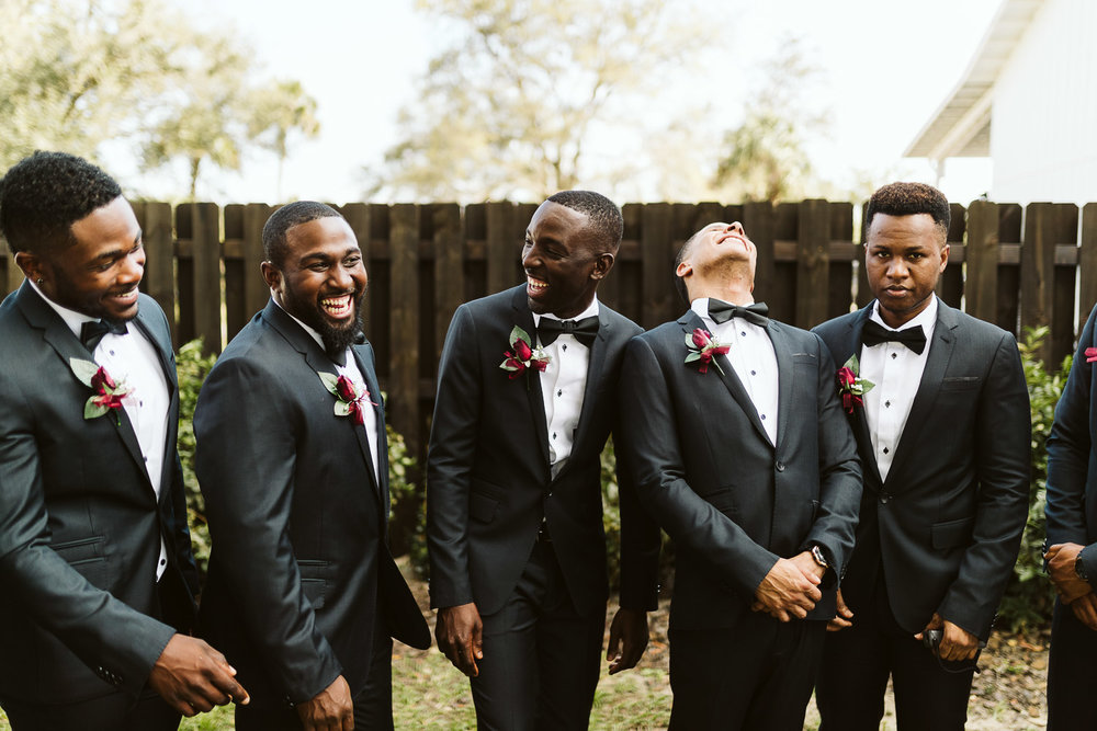  groomsmen wearing black suits 