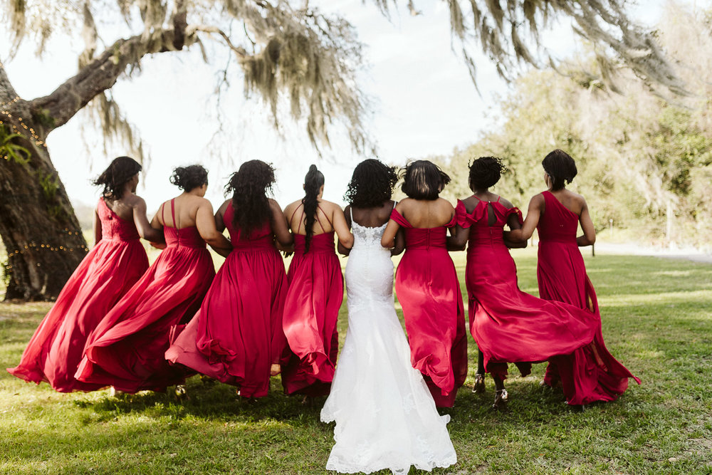  bridesmaids wearing long red dresses 