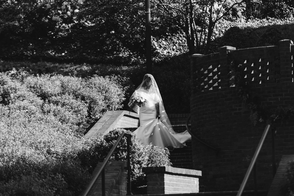  black and white picture of bride entering ceremony 