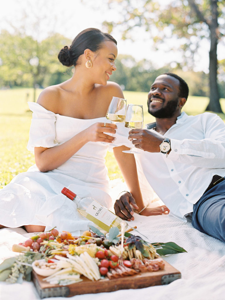 Young black couple drinking wine during a summer picnic at Constitution Gardens in Washington DC by Film photographer Kiyah C Photography