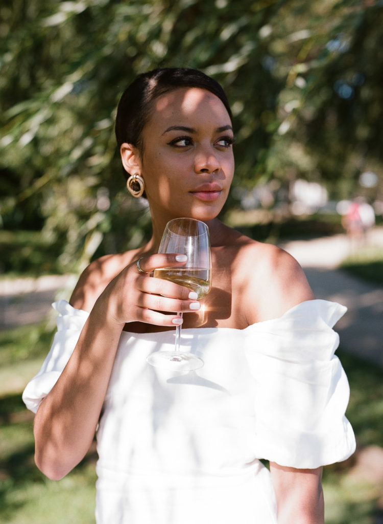 Black woman drinking wine photographed on Kodak Portra 400