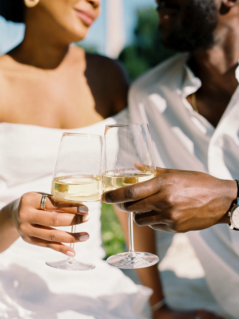 Film image of young black couple drinking wine by DC wedding photographer Kiyah C Photography