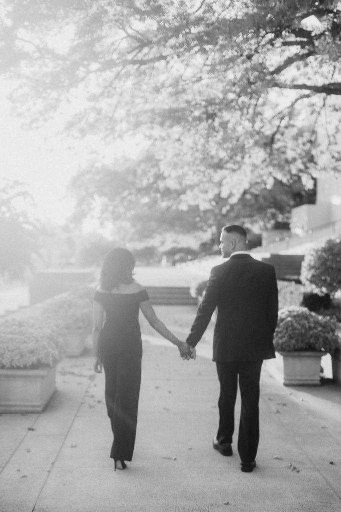 black and white image of a couple walking outside of the national gallery of art in DC
