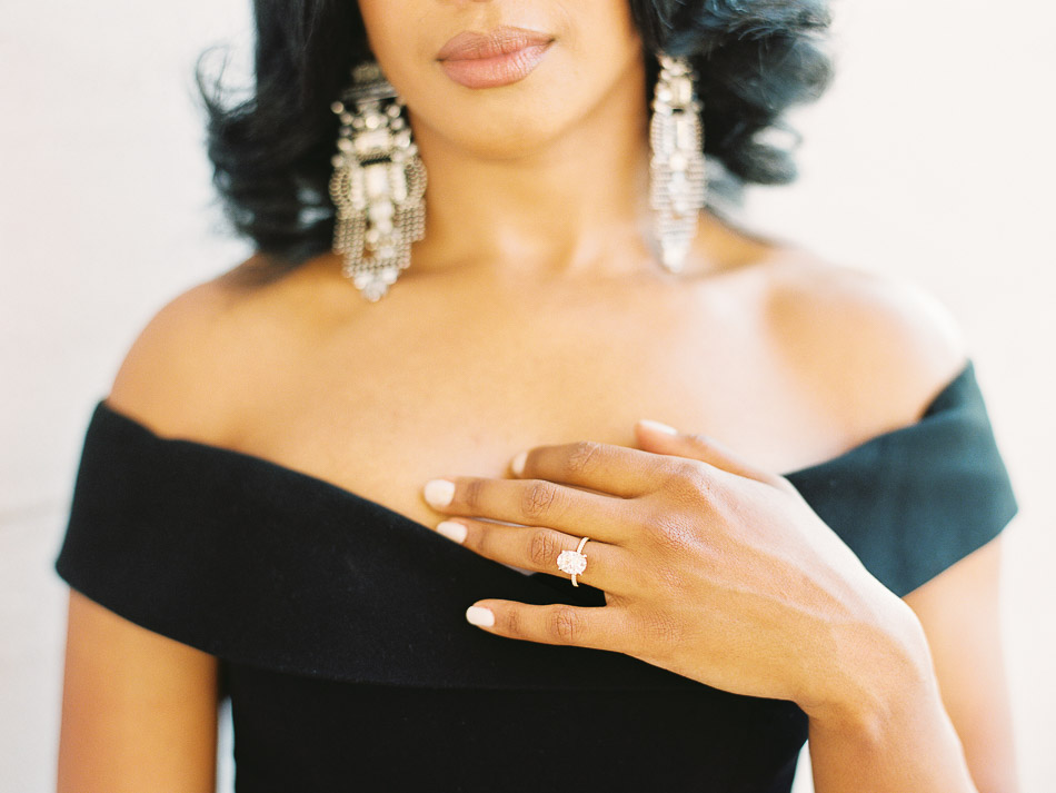Black dominican woman showing off diamond engagement ring