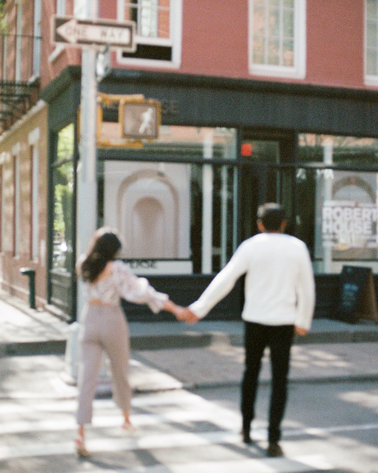 Couple holding hands during west village engagement session shot on film