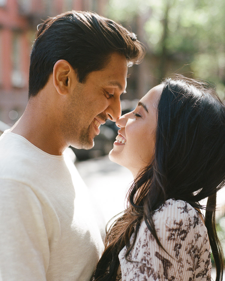 Cute couple cuddling during west village engagement session