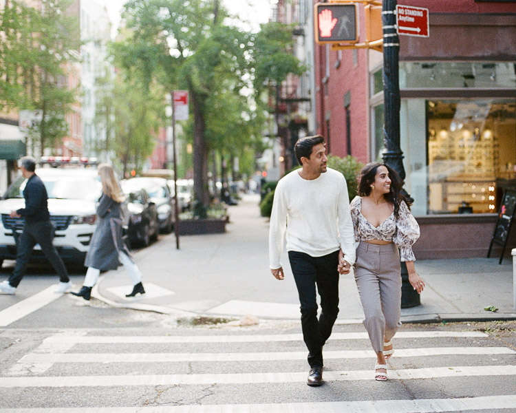Couple runs across the street during west village engagement session