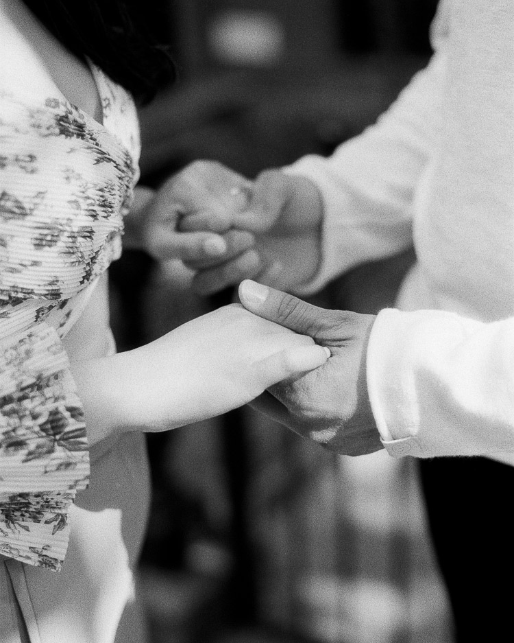 Couple holding hands on black and white film