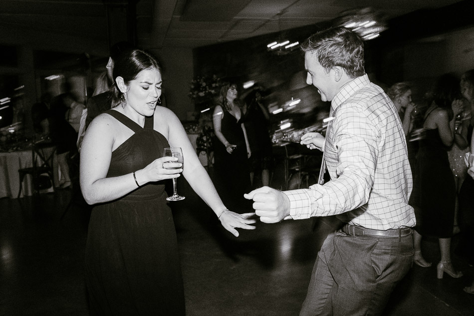 black and white photo of guests dancing at wedding reception