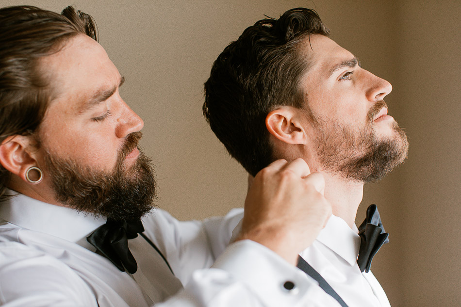 Groom and brother getting dressed at wedding