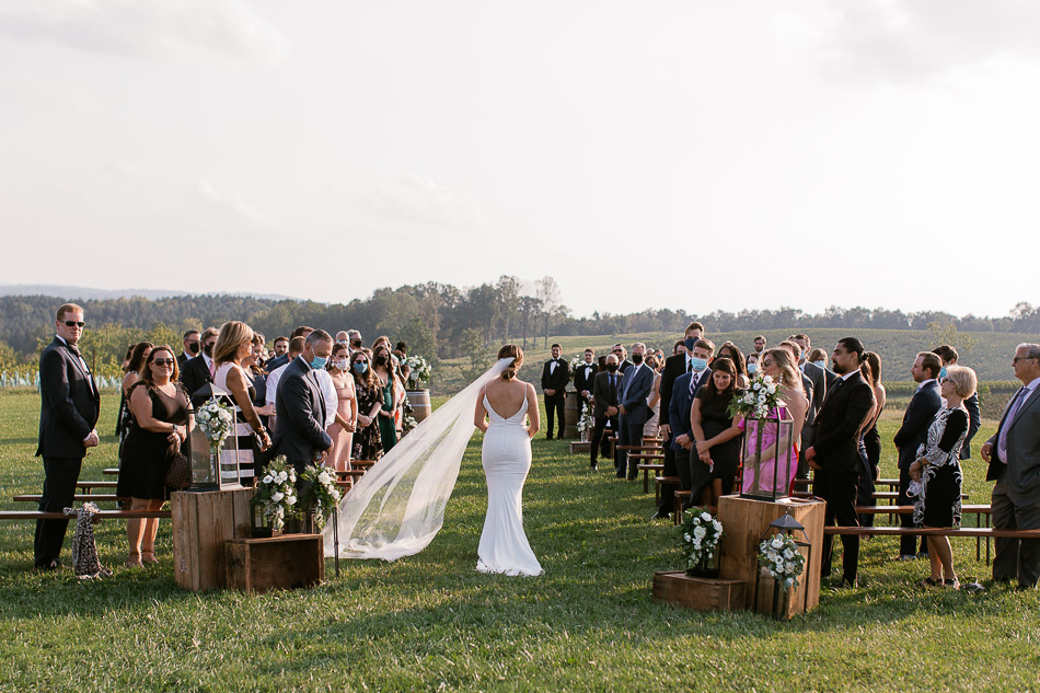 bride walking solo at stone tower winery wedding ceremony
