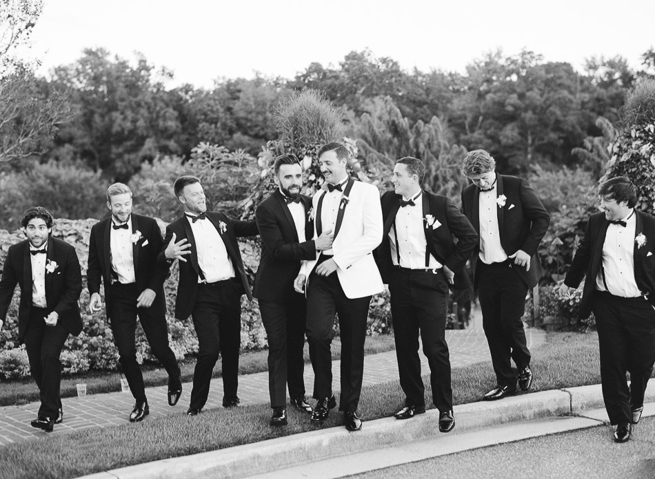 black and white film photo of groom and groomsmen on wedding day