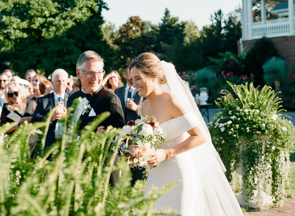 bride walks down the aisle at clubhouse at baywood delaware wedding