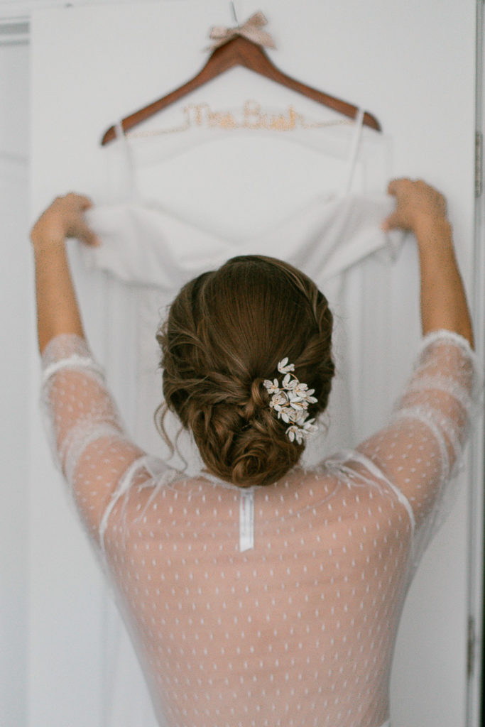 Bride with her wedding dress and custom bridal hanger