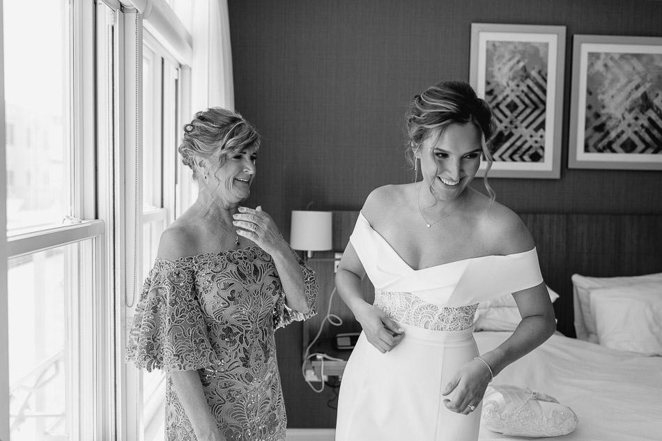 black and white photo of bride and mother getting ready on wedding day