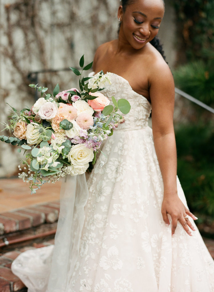 spring bouquet and black bride wearing miss hayley paige blush gown