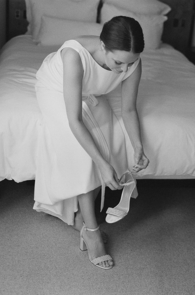 black and white image of bride getting dressed at lyle hotel in dc