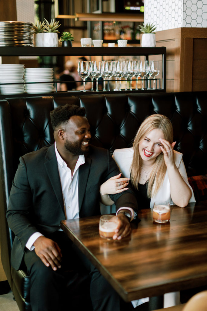 black man and white woman on a date at a cocktail bar